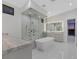 Modern bathroom featuring a freestanding tub and glass-enclosed shower with decorative tile at 641 Majestic Rim Dr, Henderson, NV 89012
