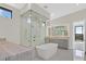 Luxurious bathroom with a soaking tub and a separate glass shower at 641 Majestic Rim Dr, Henderson, NV 89012