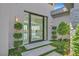 Inviting entry features modern landscaping and a glimpse of a bright, open interior at 641 Majestic Rim Dr, Henderson, NV 89012