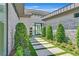 Contemporary home's entrance features a modern walkway and lush, manicured landscaping at 641 Majestic Rim Dr, Henderson, NV 89012