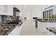 Spacious kitchen featuring marbled countertops, modern appliances, and large view windows at 641 Majestic Rim Dr, Henderson, NV 89012