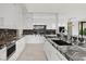 Contemporary kitchen with sleek white cabinets, granite countertops, and stainless steel appliances at 641 Majestic Rim Dr, Henderson, NV 89012