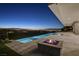 Beautiful outdoor pool and spa with a fire pit overlooking the city lights at 641 Majestic Rim Dr, Henderson, NV 89012