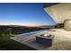Resort-style backyard with infinity pool, fire pit, and city views at sunset at 641 Majestic Rim Dr, Henderson, NV 89012