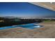 Luxurious pool and patio area with city views at twilight at 641 Majestic Rim Dr, Henderson, NV 89012