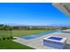 Beautiful backyard pool and lounge area overlooking lush green hills and mountain views at 641 Majestic Rim Dr, Henderson, NV 89012