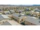 Neighborhood aerial view of a two-story home with solar panels in a residential area at 7051 Denio Island St, North Las Vegas, NV 89084