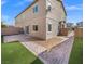 Backyard featuring patio with grassy area and the exterior of the house at 7051 Denio Island St, North Las Vegas, NV 89084