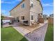 Backyard featuring patio with outdoor furniture and barbecue, grassy area, and the house at 7051 Denio Island St, North Las Vegas, NV 89084