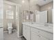 Bathroom with double sink vanity, tiled flooring, white cabinets and neutral walls at 7051 Denio Island St, North Las Vegas, NV 89084