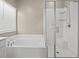 Bathroom featuring a soaking tub and a glass-enclosed shower at 7051 Denio Island St, North Las Vegas, NV 89084
