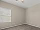 Bedroom with neutral walls, carpet flooring, and bright natural light from a window at 7051 Denio Island St, North Las Vegas, NV 89084