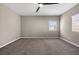Bedroom with neutral carpet, ceiling fan and natural light from the window at 7051 Denio Island St, North Las Vegas, NV 89084