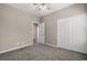 Bedroom with neutral walls, carpet flooring, and closet, offering simple style at 7051 Denio Island St, North Las Vegas, NV 89084