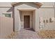 Inviting entrance with a covered doorway and brick pathway leading to the front door at 7051 Denio Island St, North Las Vegas, NV 89084