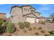 Charming stucco two-story home with a brick driveway and well-maintained landscaping at 7051 Denio Island St, North Las Vegas, NV 89084