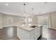 Kitchen island with granite countertop overlooking the living area and backyard at 7051 Denio Island St, North Las Vegas, NV 89084