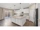 Bright kitchen with granite counters, a center island, and access to outdoor space at 7051 Denio Island St, North Las Vegas, NV 89084