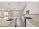 Modern kitchen featuring granite counters, island, and stainless steel appliances at 7051 Denio Island St, North Las Vegas, NV 89084