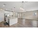 Open kitchen with granite counters, center island, stainless appliances, and bright living space at 7051 Denio Island St, North Las Vegas, NV 89084