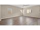 Large open living room featuring beautiful hardwood floors and ample natural light at 7051 Denio Island St, North Las Vegas, NV 89084