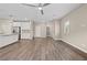 Bright, open living room boasts modern ceiling fan, wood floors, and neutral paint at 7051 Denio Island St, North Las Vegas, NV 89084