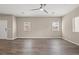 Expansive living room with hardwood flooring, neutral walls, and plenty of natural light from large windows at 7051 Denio Island St, North Las Vegas, NV 89084