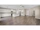 Open concept living area with island kitchen, stainless appliances, and wood floors at 7051 Denio Island St, North Las Vegas, NV 89084