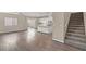 Open concept living room showcasing hardwood floors, stairs, and a spacious design at 7051 Denio Island St, North Las Vegas, NV 89084