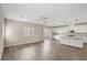Spacious open concept living area with hardwood floors, a sliding glass door and a gourmet kitchen at 7051 Denio Island St, North Las Vegas, NV 89084