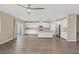 Open floor plan showcasing the kitchen with an island and living area with sliding doors at 7051 Denio Island St, North Las Vegas, NV 89084