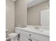 Bright powder room featuring a white vanity and modern fixtures at 7051 Denio Island St, North Las Vegas, NV 89084