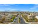 Street view captures the Stone Creek neighborhood entrance with mountain views under a clear blue sky at 7051 Denio Island St, North Las Vegas, NV 89084