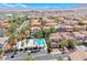 Wide aerial view of the neighborhood highlighting community pool, and residential landscaping at 708 Point Bluff St, Henderson, NV 89002