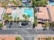 Aerial view of the community pool, lounge chairs, palm trees, splash pad, and nearby parking at 708 Point Bluff St, Henderson, NV 89002