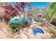 Beautiful backyard featuring a pool, spa, lush landscaping, and serene ambiance at 708 Point Bluff St, Henderson, NV 89002