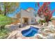 Beautiful backyard with a private pool, lush landscaping, and covered patio, ideal for outdoor entertaining at 708 Point Bluff St, Henderson, NV 89002