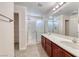 Bathroom featuring a double sink vanity and large glass shower, combining style and functionality at 708 Point Bluff St, Henderson, NV 89002