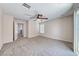 Carpeted bedroom offers a ceiling fan and a large window for plenty of natural light at 708 Point Bluff St, Henderson, NV 89002