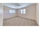 Neutral bedroom featuring carpet, two windows, a ceiling fan with light, and electrical outlets at 708 Point Bluff St, Henderson, NV 89002
