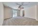 Bright bedroom featuring neutral carpet and a sliding glass door leading to a private balcony at 708 Point Bluff St, Henderson, NV 89002