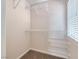 Walk-in closet featuring carpet flooring, wire shelving, and a window for natural light at 708 Point Bluff St, Henderson, NV 89002