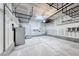 Spacious garage with overhead storage racks, concrete flooring, and utility connections at 708 Point Bluff St, Henderson, NV 89002