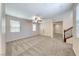 Spacious living room with carpet flooring, ceiling fan and staircase, providing ample living space at 708 Point Bluff St, Henderson, NV 89002