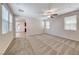 Expansive living room filled with light and plush carpeting, perfect for entertaining and Gathering enjoyment at 708 Point Bluff St, Henderson, NV 89002