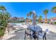 Relaxing pool area with comfortable lounge chairs and tables, perfect for unwinding and socializing under the palms at 708 Point Bluff St, Henderson, NV 89002