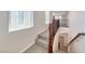 Carpeted staircase with decorative wood banister leading to the upper level of the home at 708 Point Bluff St, Henderson, NV 89002