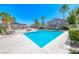 Sparkling swimming pool surrounded by lush palm trees, offering a refreshing escape and resort-style living at 708 Point Bluff St, Henderson, NV 89002