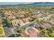Overhead view of the neighborhood with tile roofed homes, mature trees and landscaping in a desert climate at 7411 Brittlethorne Ave, Las Vegas, NV 89131