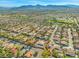 Expansive aerial view of a residential neighborhood, showcasing the community layout and nearby mountain views at 7411 Brittlethorne Ave, Las Vegas, NV 89131